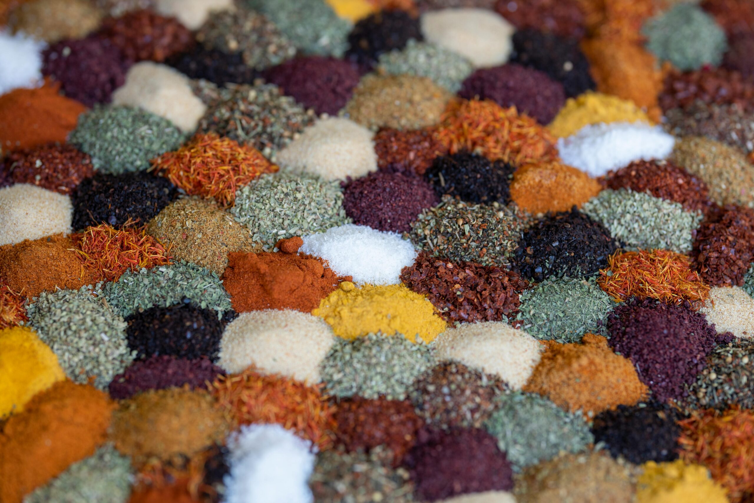 A vibrant close-up of diverse spices neatly arranged, showcasing their variety and richness.